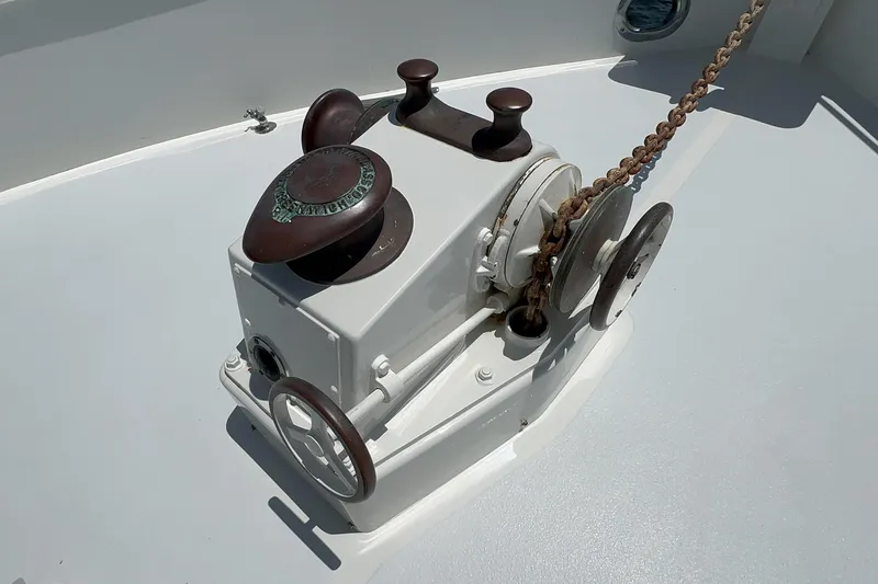 Slide: The Image of 1971 Grand Banks boat windlass with chain on deck, featuring vintage design elements. - 11