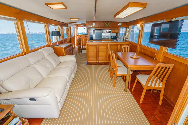 Slide: The Image of Interior of a 1971 Grand Banks yacht with cozy seating and dining area. - 2