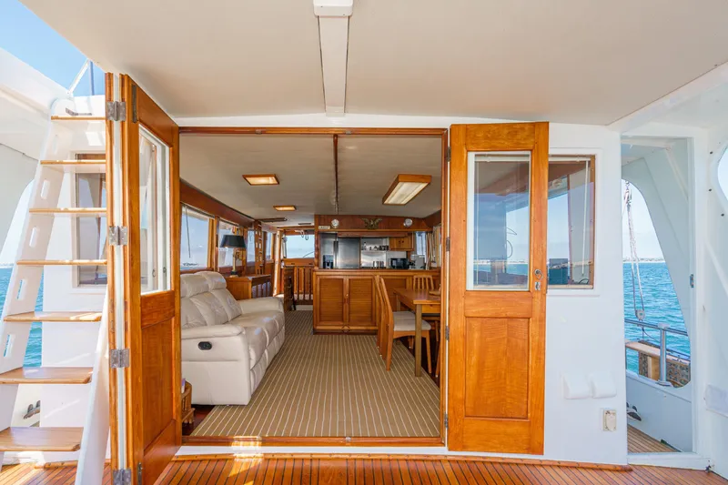 Slide: The Image of Interior view of a 1971 Grand Banks yacht with wooden doors and comfortable seating. - 21