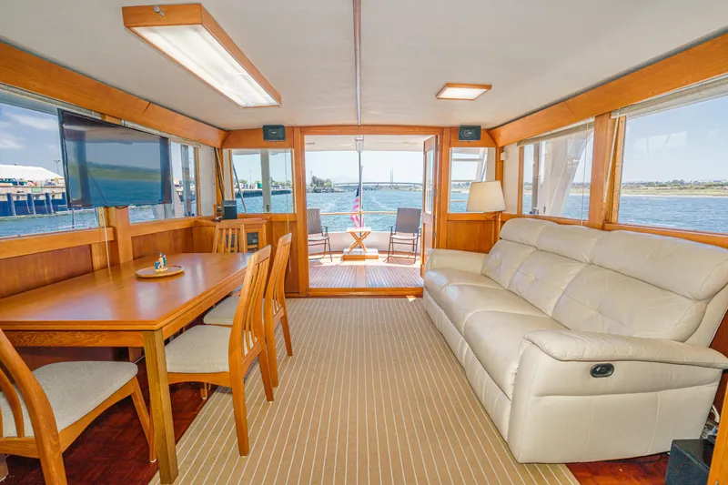 Slide: The Image of Interior of a 1971 Grand Banks yacht with dining area, sofa, and ocean view. - 22