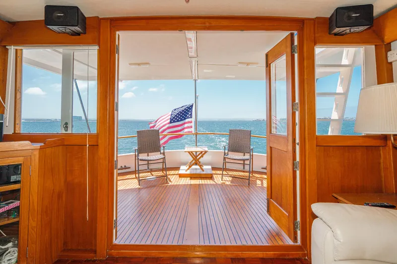 Slide: The Image of Interior view of a 1971 Grand Banks yacht with ocean view and American flag. - 23