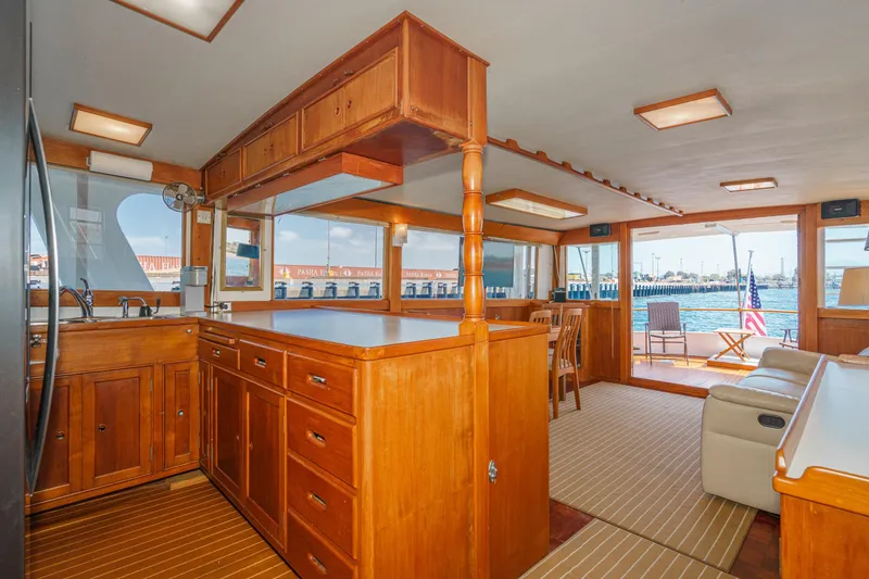 Slide: The Image of Interior of a 1971 Grand Banks boat with wooden cabinetry and waterfront view. - 26