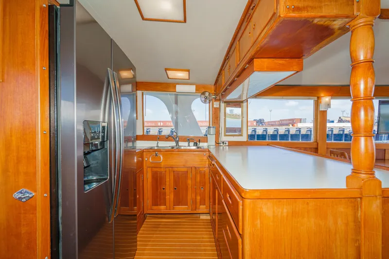 Slide: The Image of 1971 Grand Banks yacht kitchen with wooden cabinetry and modern stainless steel appliances. - 27