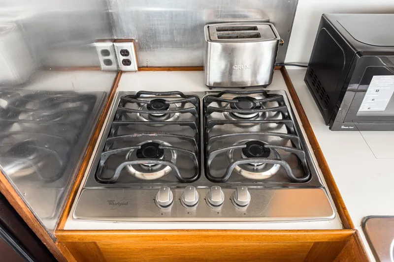 Slide: The Image of 1971 Grand Banks kitchen with Whirlpool gas stove, toaster, and microwave. - 33