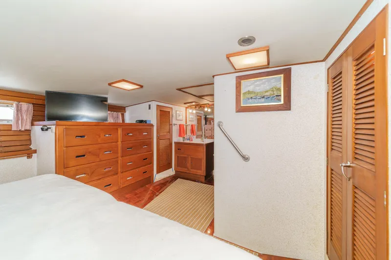 Slide: The Image of 1971 Grand Banks interior with wooden cabinetry, TV, and nautical decor. - 38