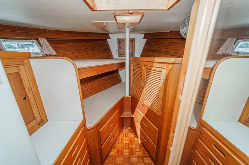 Slide: The Image of 1971 Grand Banks boat interior with wooden cabinetry and bunk beds. - 46
