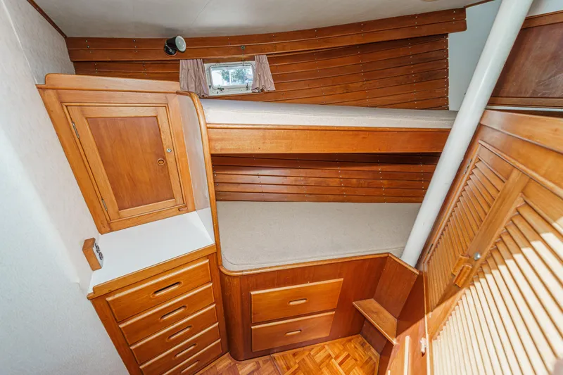 Slide: The Image of 1971 Grand Banks boat interior with wooden cabinetry and bunk beds. - 47