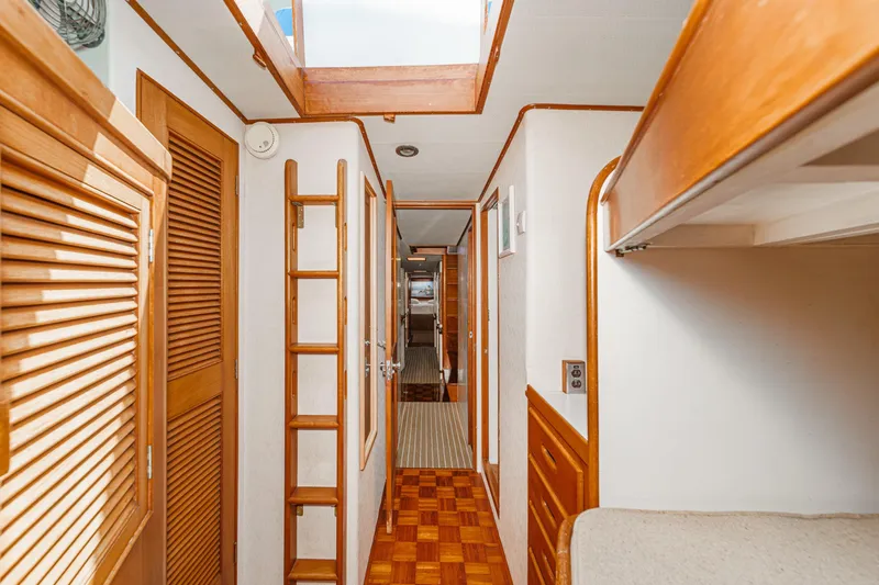 Slide: The Image of Interior of a 1971 Grand Banks boat with wooden finishes and ladder. - 48
