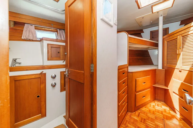 Slide: The Image of 1971 Grand Banks boat interior with wooden cabinetry, bunk beds, and parquet flooring. - 49