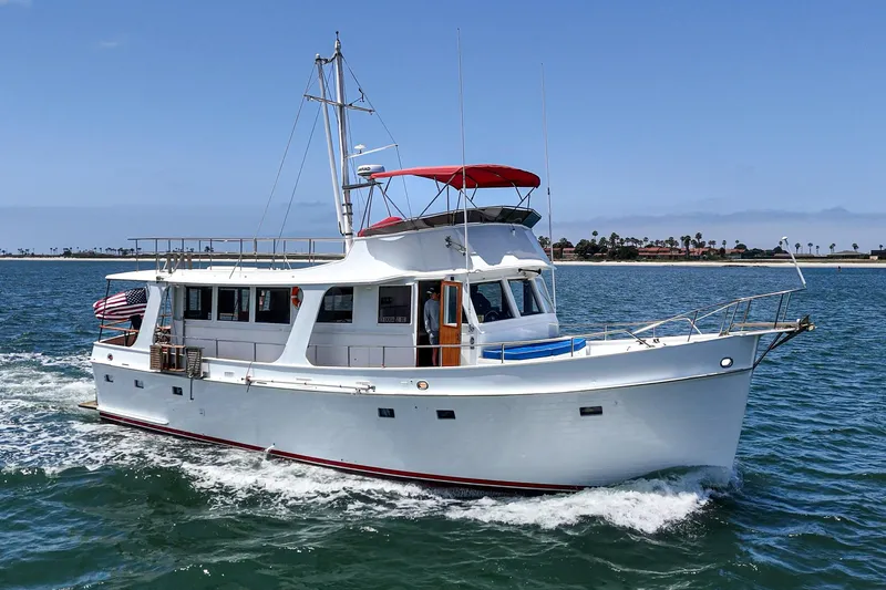 Slide: The Image of 1971 Grand Banks yacht cruising on open water with clear skies. - 5