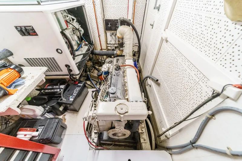 Slide: The Image of Engine room of a 1971 Grand Banks boat with visible machinery and equipment. - 54