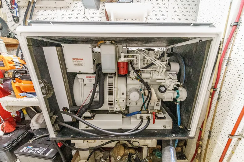 Slide: The Image of Engine compartment of a 1971 Grand Banks boat, showcasing mechanical components and wiring. - 55