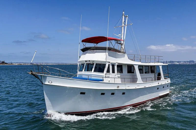 Slide: The Image of 1971 Grand Banks yacht cruising on open water under a clear blue sky. - 7