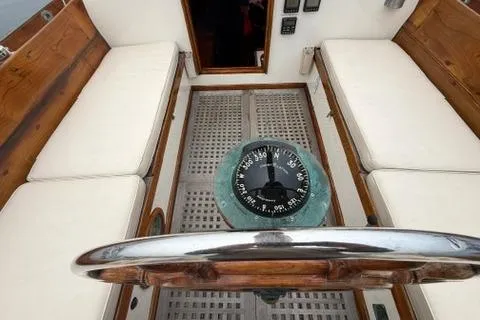 Slide: The Image of Interior view of a 1962 Lapworth Sloop sailboat with compass and wooden seating. - 10