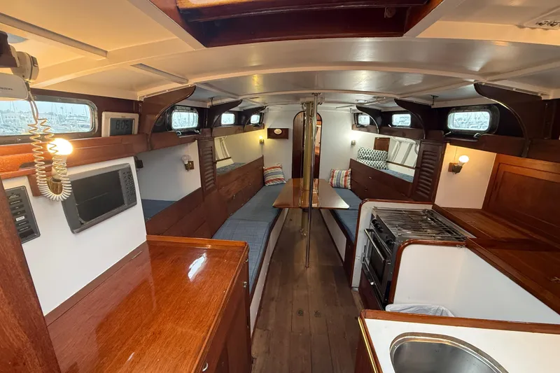 Slide: The Image of Interior of a 1962 Lapworth Sloop sailboat with wooden furnishings and cozy seating. - 15