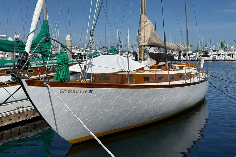 Slide: The Image of Vintage 1962 Lapworth Sloop sailboat docked in a marina with other boats. - 2