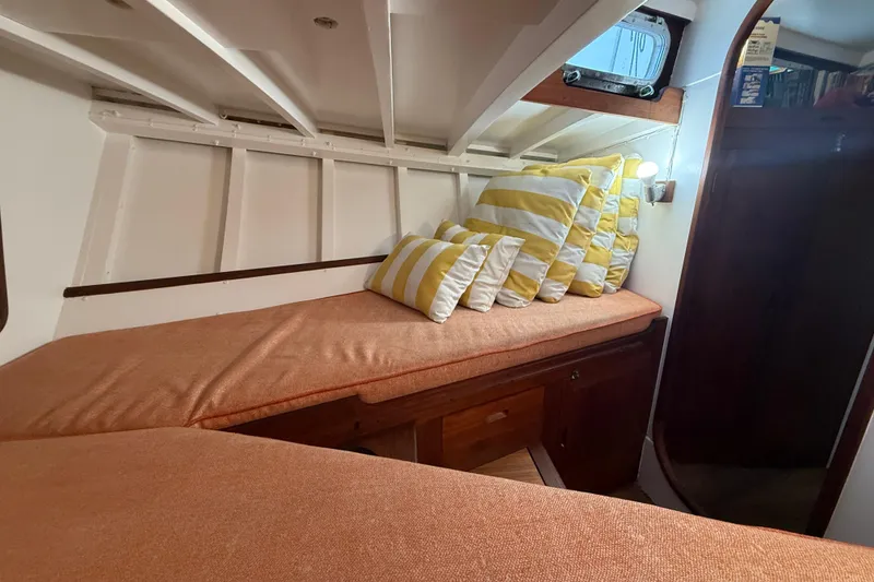 Slide: The Image of Cozy cabin interior of a 1962 Lapworth Sloop with striped cushions and wooden accents. - 30