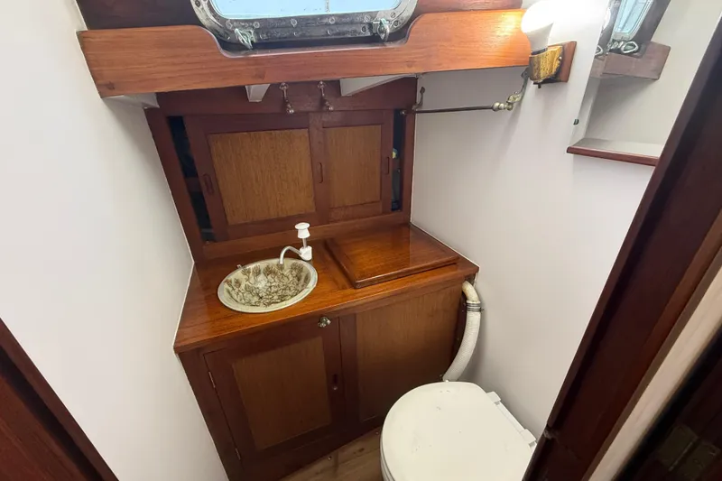 Slide: The Image of 1962 Lapworth Sloop bathroom with wooden cabinetry and vintage sink. - 32