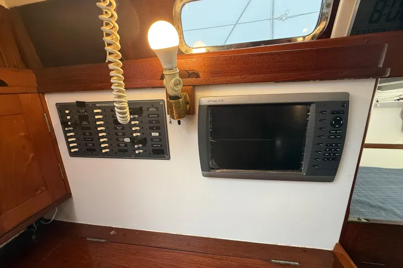 Slide: The Image of Interior of a 1962 Lapworth Sloop featuring navigation equipment and control panel. - 33