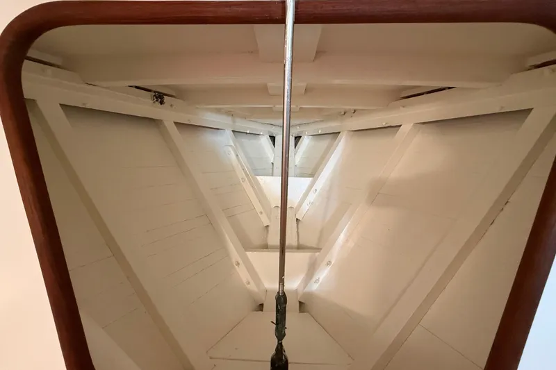 Slide: The Image of Interior view of a 1962 Lapworth Sloop sailboat, showcasing wooden structure and rigging. - 34