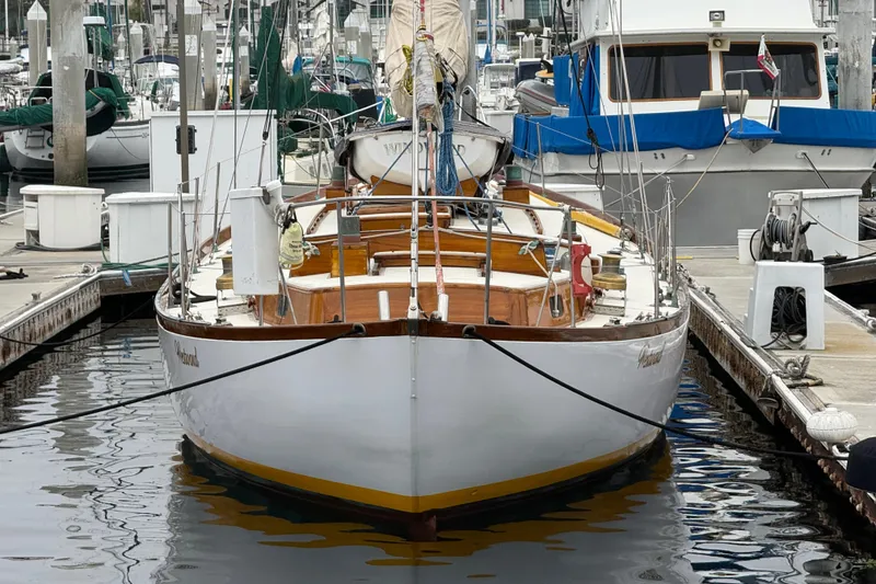 Slide: The Image of 1962 Lapworth Sloop docked at marina, surrounded by other boats. - 38