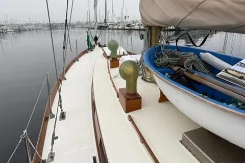 Slide: The Image of 1962 Lapworth Sloop sailboat docked, featuring classic design and deck details. - 4