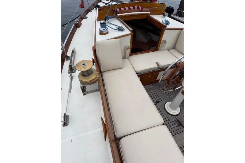 Slide: The Image of 1962 Lapworth Sloop interior with cushioned seating and wooden steering wheel. - 5