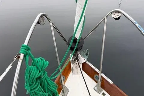 Slide: The Image of Bow of a 1962 Lapworth Sloop with green ropes and metal railings. - 7