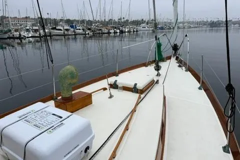 Slide: The Image of 1962 Lapworth Sloop sailboat docked in a marina, surrounded by other boats. - 8