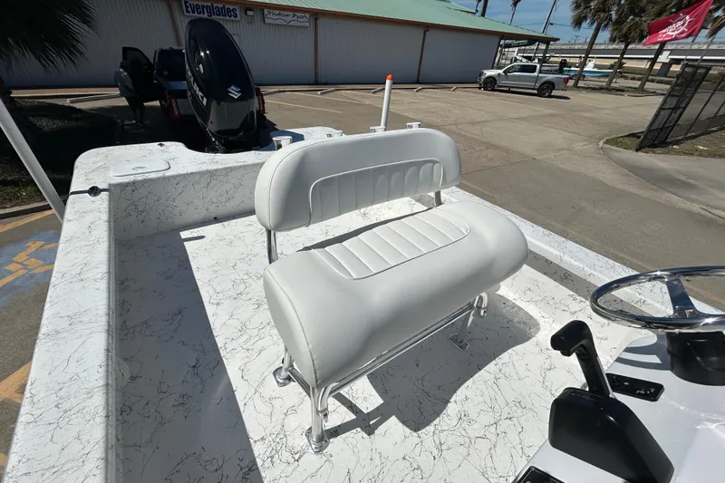 Slide: The Image of 2026 Coastal Skiff 271 boat interior with white seating and steering console. - 11