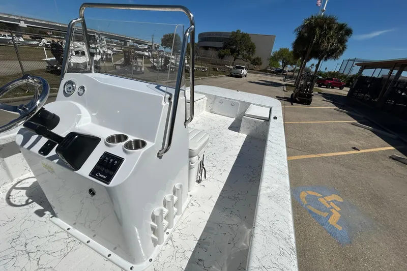Slide: The Image of 2026 Coastal Skiff 271 boat with sleek console design and spacious deck in marina setting. - 13