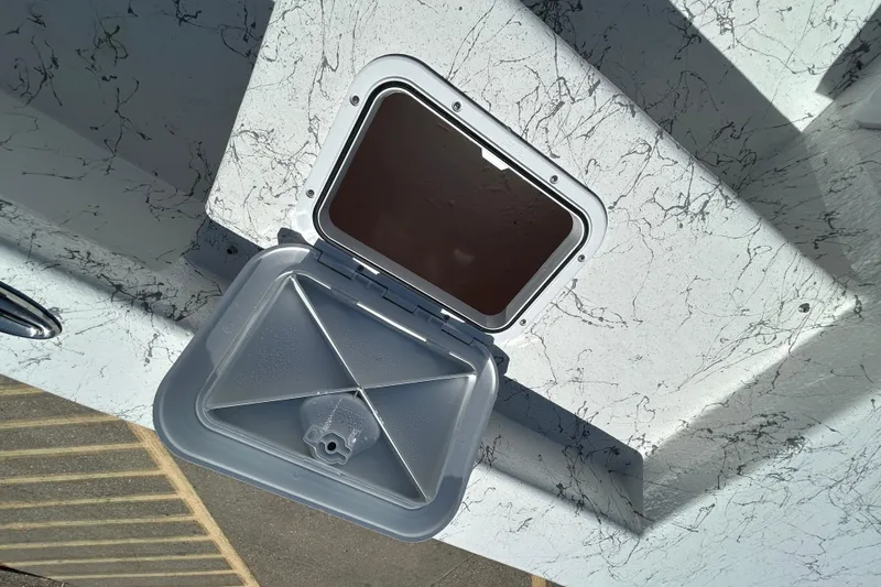 Slide: The Image of Open hatch on 2026 Coastal Skiff 271 boat, showing interior compartment. - 16
