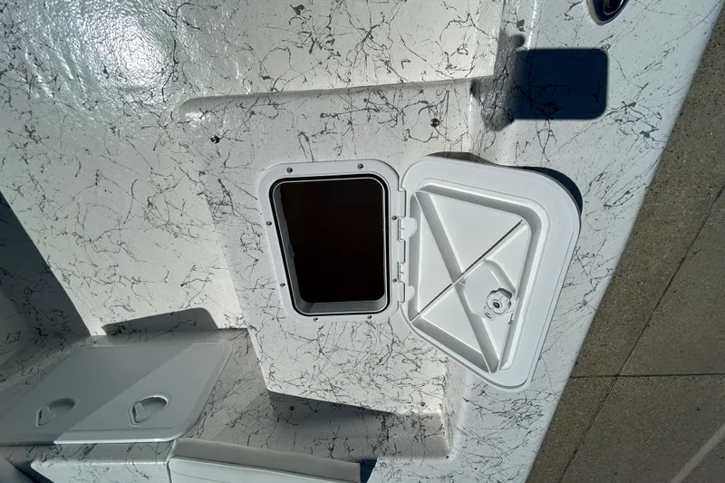 Slide: The Image of Open hatch on 2026 Coastal Skiff 271 boat with textured surface. - 17