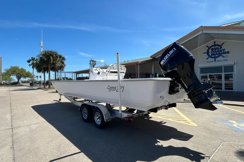 Slide: The Image of 2026 Coastal Skiff 271 boat on trailer with Suzuki outboard motor at Gulf Coast Marine. - 8