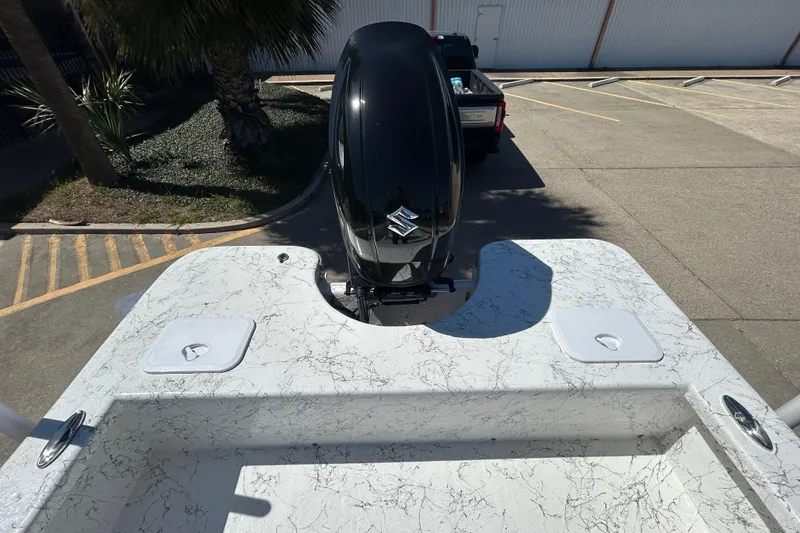 Slide: The Image of 2026 Coastal Skiff 271 boat with outboard motor in a parking lot. - 9