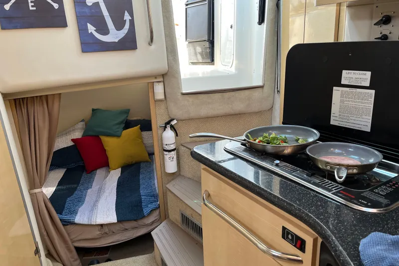 Slide: The Image of Interior of 2001 Maxum 3300 SCR boat with cozy bed and compact kitchen. - 11