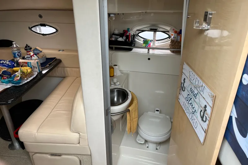 Slide: The Image of Interior of 2001 Maxum 3300 SCR boat with dining area and compact bathroom. - 13