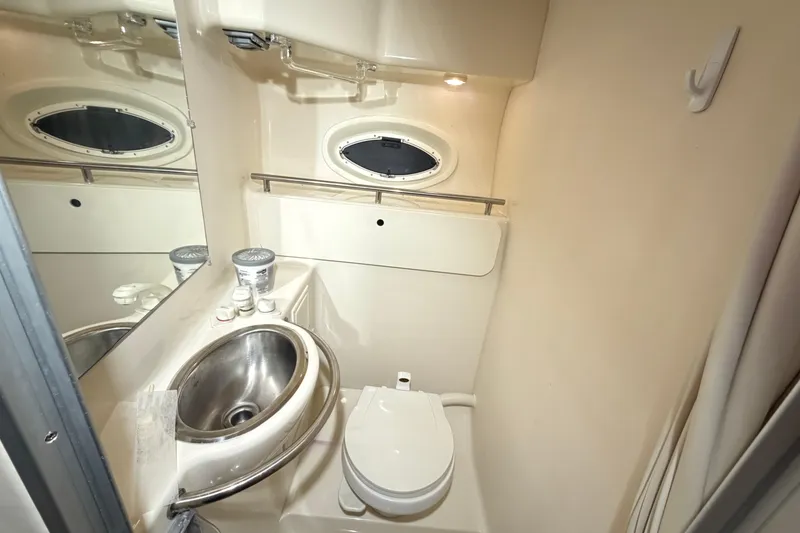 Slide: The Image of Compact bathroom in 2001 Maxum 3300 SCR yacht with stainless steel sink and toilet. - 14