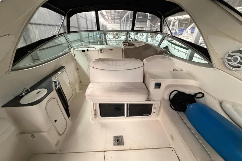 Slide: The Image of 2001 Maxum 3300 SCR boat interior with seating, sink, and storage compartments. - 15