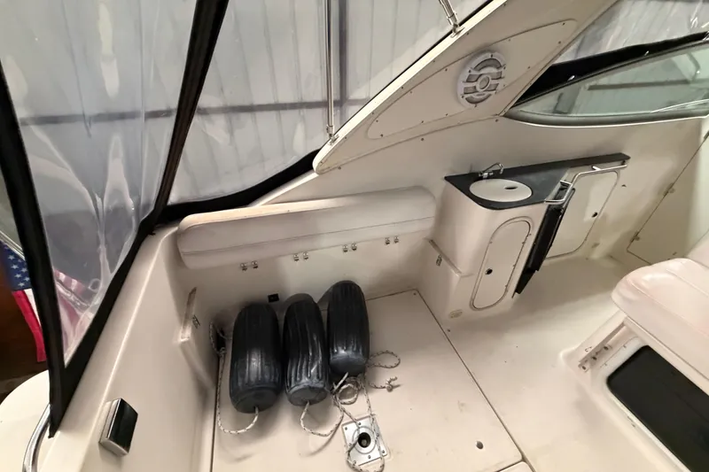 Slide: The Image of 2001 Maxum 3300 SCR boat interior with seating, storage, and fenders. - 17