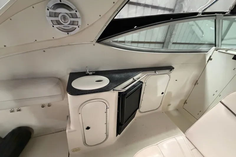 Slide: The Image of 2001 Maxum 3300 SCR boat interior with sink, counter, and storage cabinets. - 19