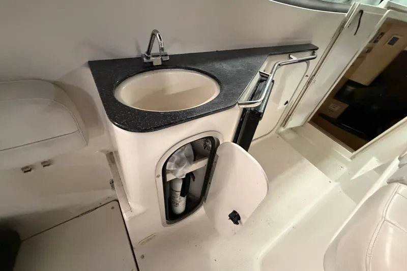 Slide: The Image of 2001 Maxum 3300 SCR boat interior with sink and storage compartment. - 20