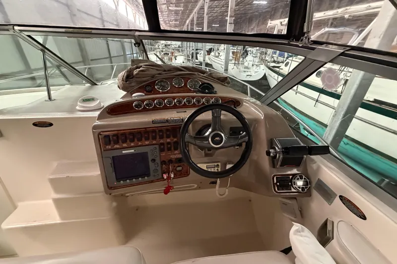 Slide: The Image of 2001 Maxum 3300 SCR boat cockpit with steering wheel and control panel. - 23