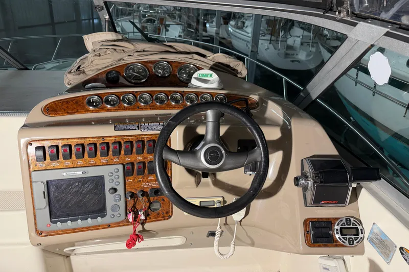 Slide: The Image of Cockpit of 2001 Maxum 3300 SCR boat with steering wheel and control panel. - 24