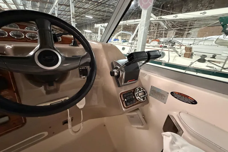 Slide: The Image of 2001 Maxum 3300 SCR boat cockpit with steering wheel and control panel. - 26