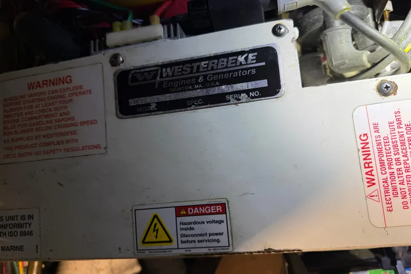 Slide: The Image of Westerbeke engine with warning labels in a 2001 Maxum 3300 SCR boat. - 32