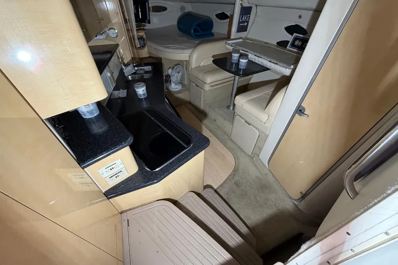 Slide: The Image of 2001 Maxum 3300 SCR cabin interior with kitchenette, seating, and table. - 35