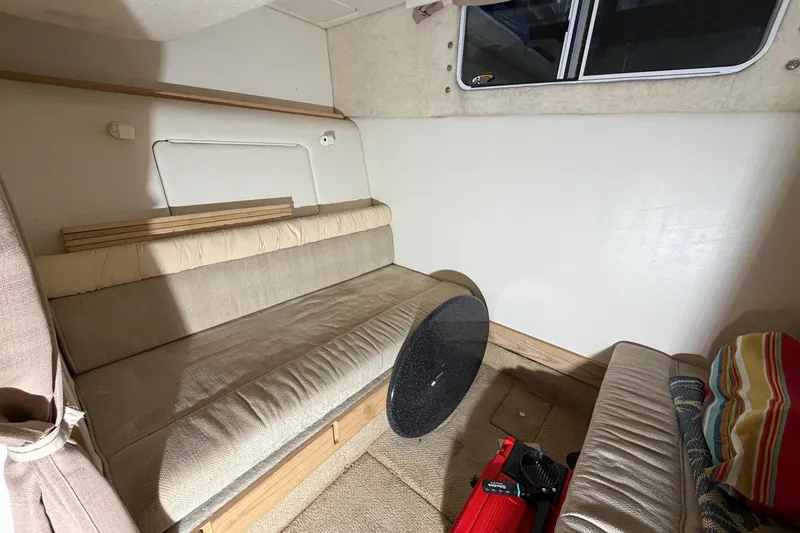 Slide: The Image of Interior of 2001 Maxum 3300 SCR boat with beige seating and window. - 36