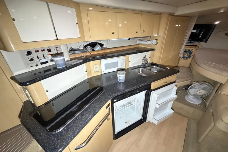 Slide: The Image of 2001 Maxum 3300 SCR yacht interior kitchen with modern appliances and compact design. - 37