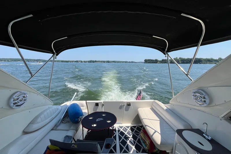 Slide: The Image of 2001 Maxum 3300 SCR boat interior with lake view and American flag. - 4